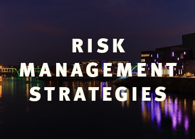RISK MANAGEMENT STRATEGIES. IMAGE OF river and bridge at night DOWNTOWN EAU CLAIRE, WISCONSIN AT NIGHT